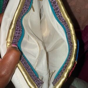 Elegant White and Gold Cosmetic Bag with Decorative Trim